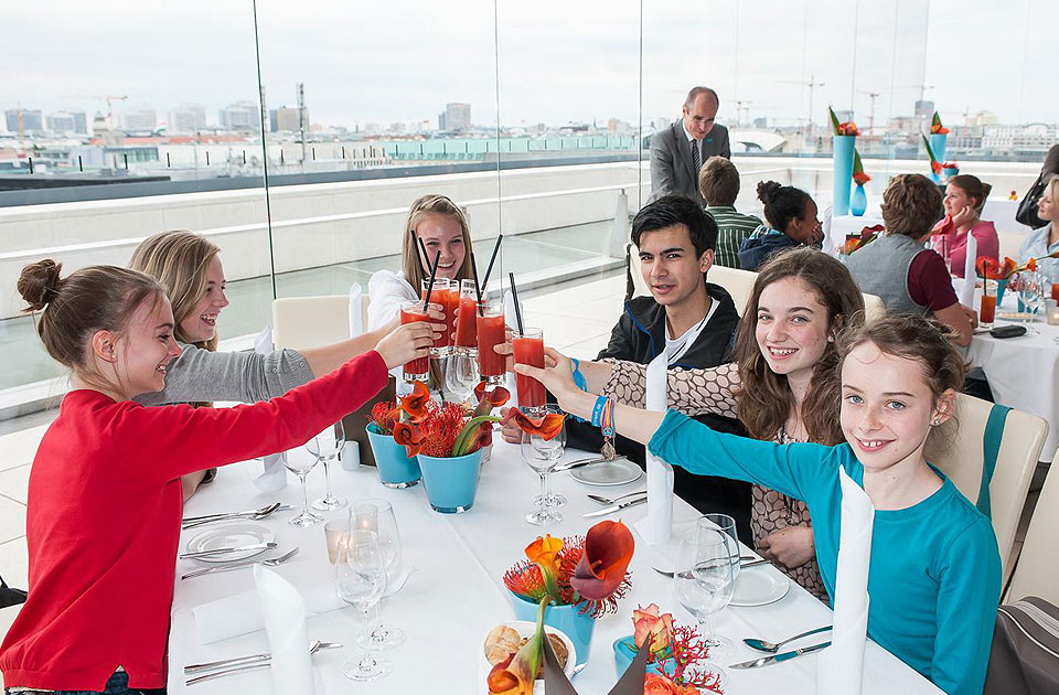 The young people sitting at the table in the restaurant.